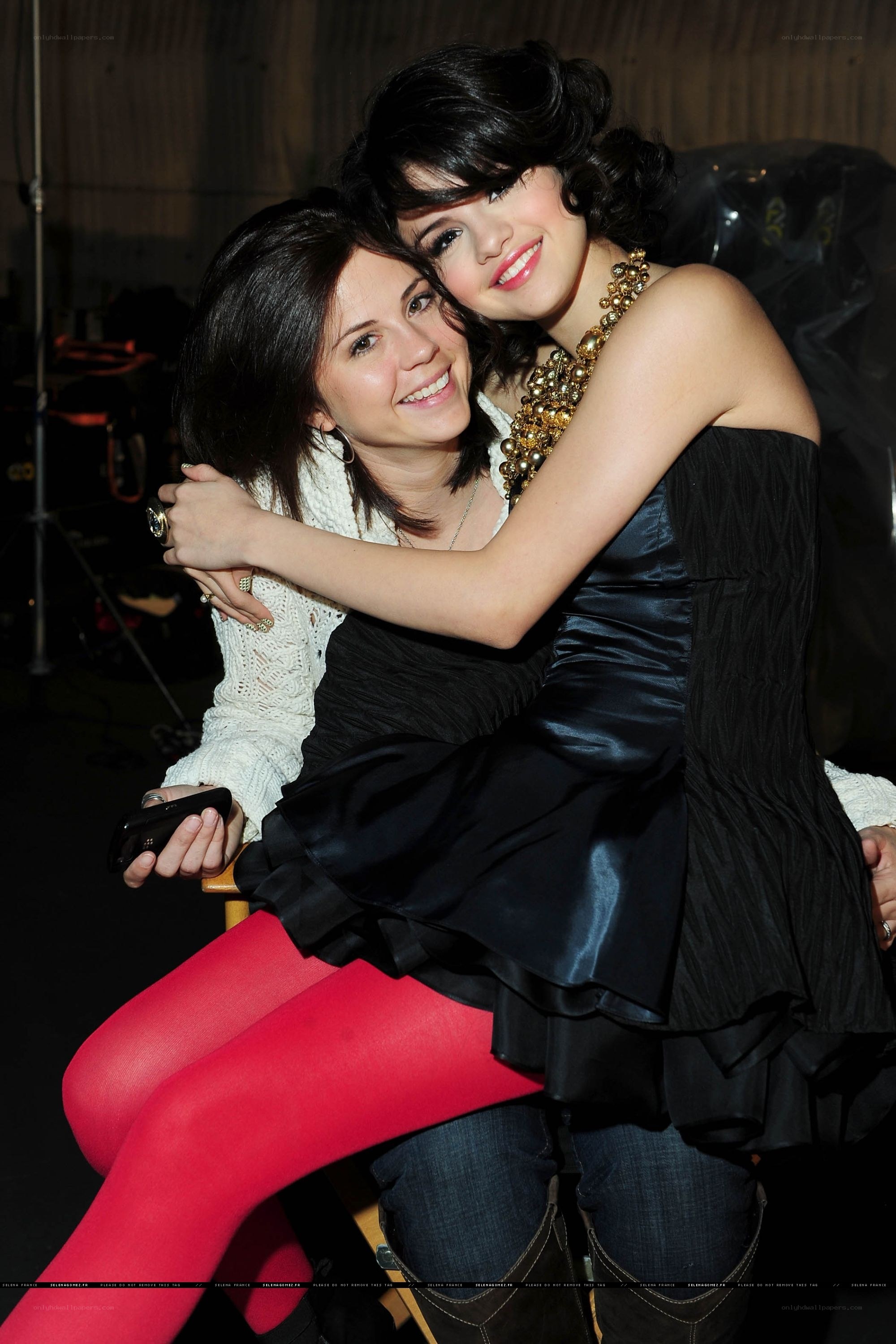 Two women hugging backstage