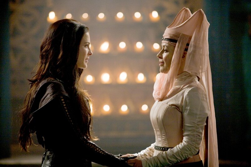 Two women in a candlelit scene