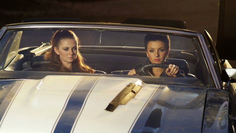 Two women in a convertible car