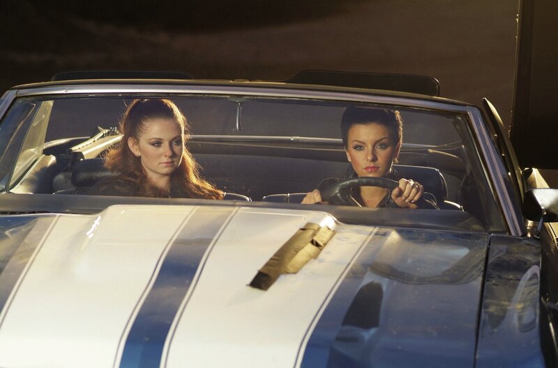Two women in a convertible car