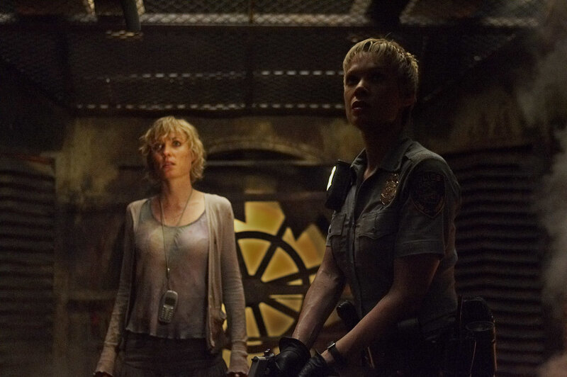 Two women in a dimly lit corridor