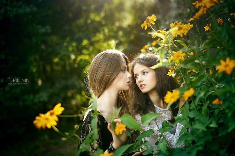 Two women in a flower garden