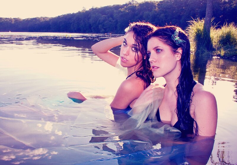 Two women in a lake at sunset
