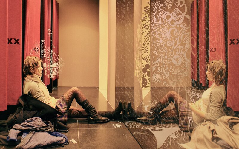 Two women in a mirrored room