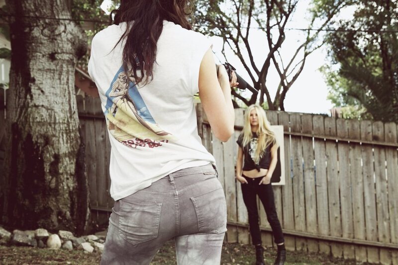 Two women in backyard with toy gun