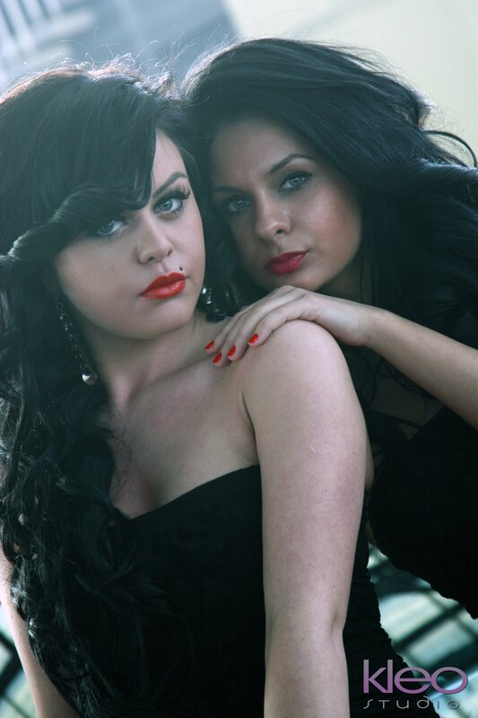 two women in black dresses