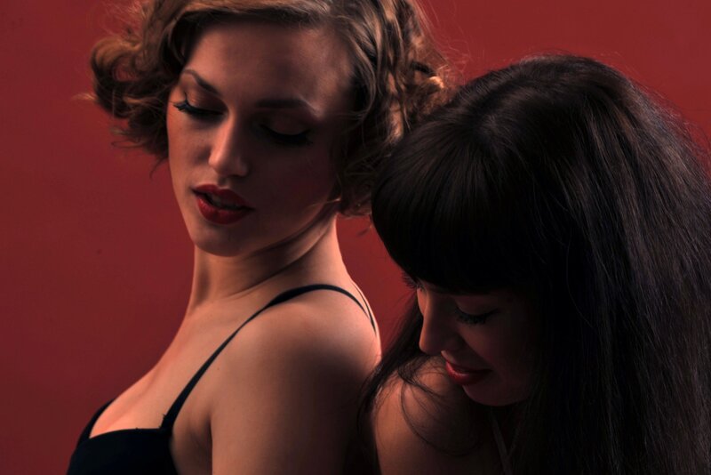 two women in black tops