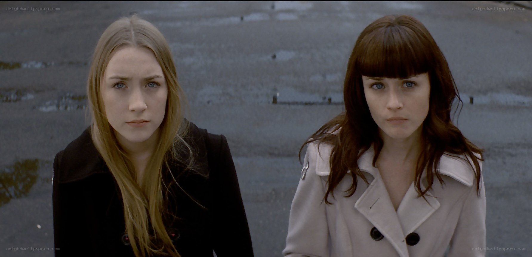 Two women in coats looking forward