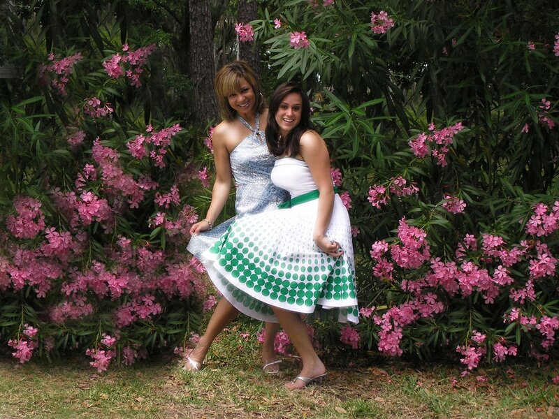 Two women in dresses by flowers