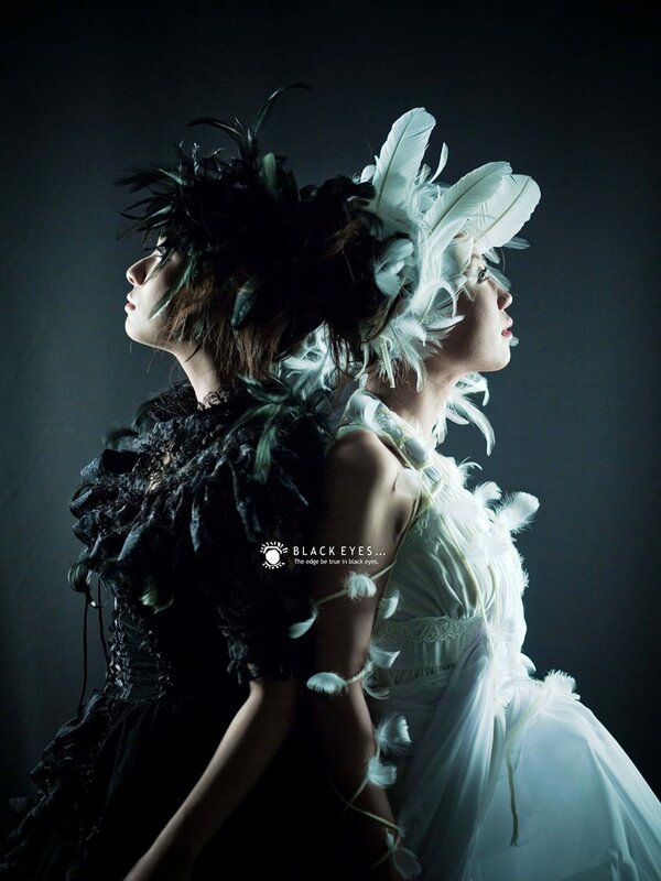 Two women in feathered costumes