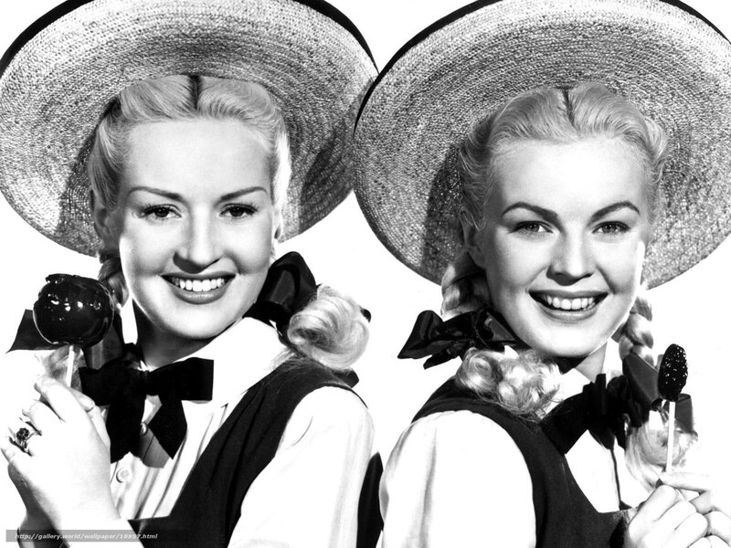 Two women in hats smiling