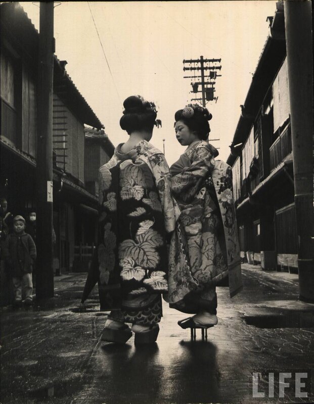 Two women in kimonos on a street