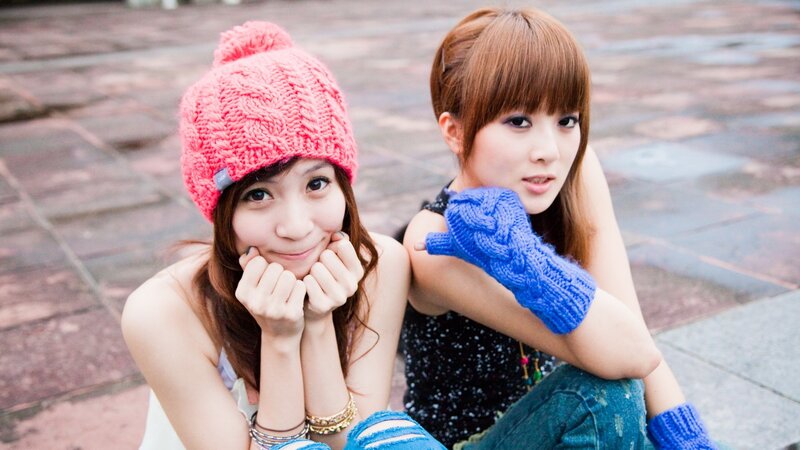 Two women in knit hats and gloves