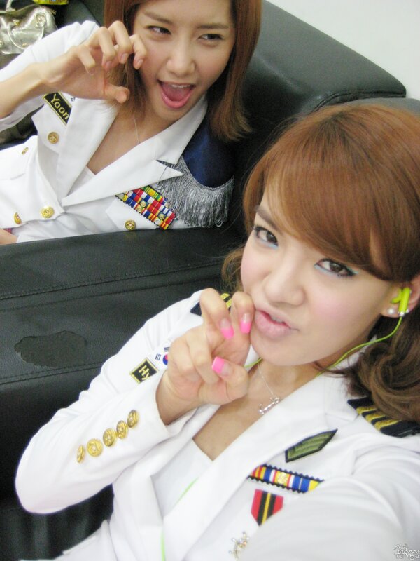 Two women in military-style uniforms
