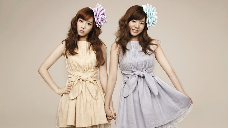 two women in pastel dresses