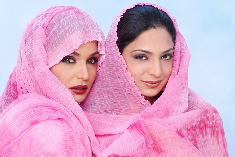 Two women in pink headscarves