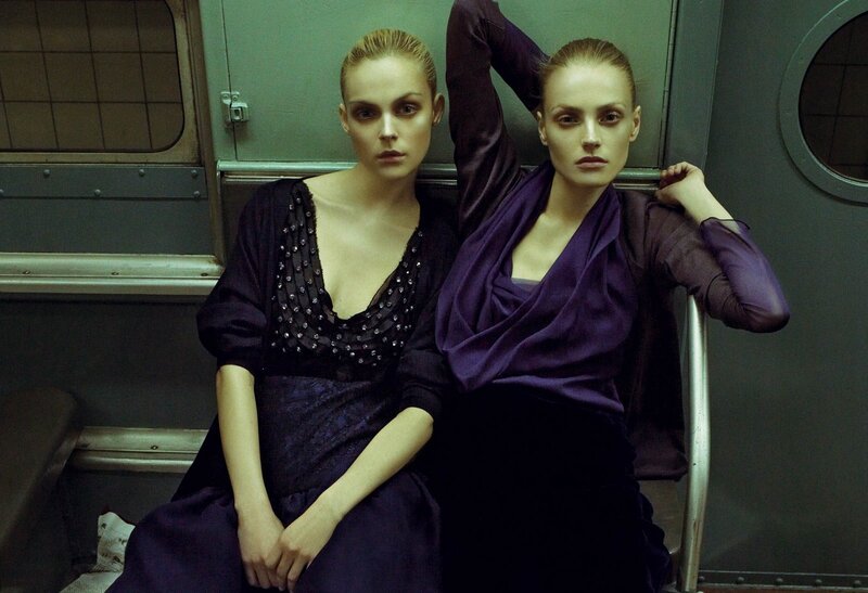 Two women in purple on a subway
