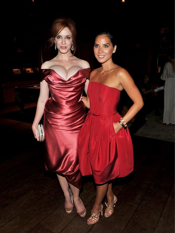 Two women in red dresses at event