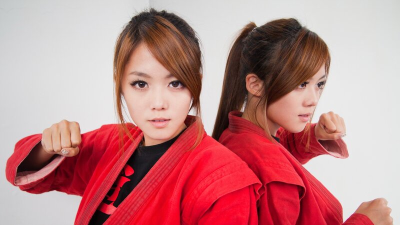 Two women in red martial arts uniforms
