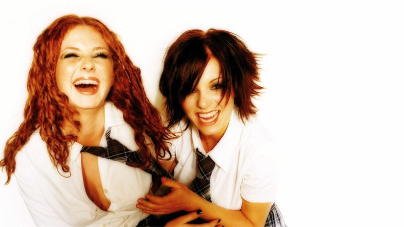 two women in school uniforms laughing