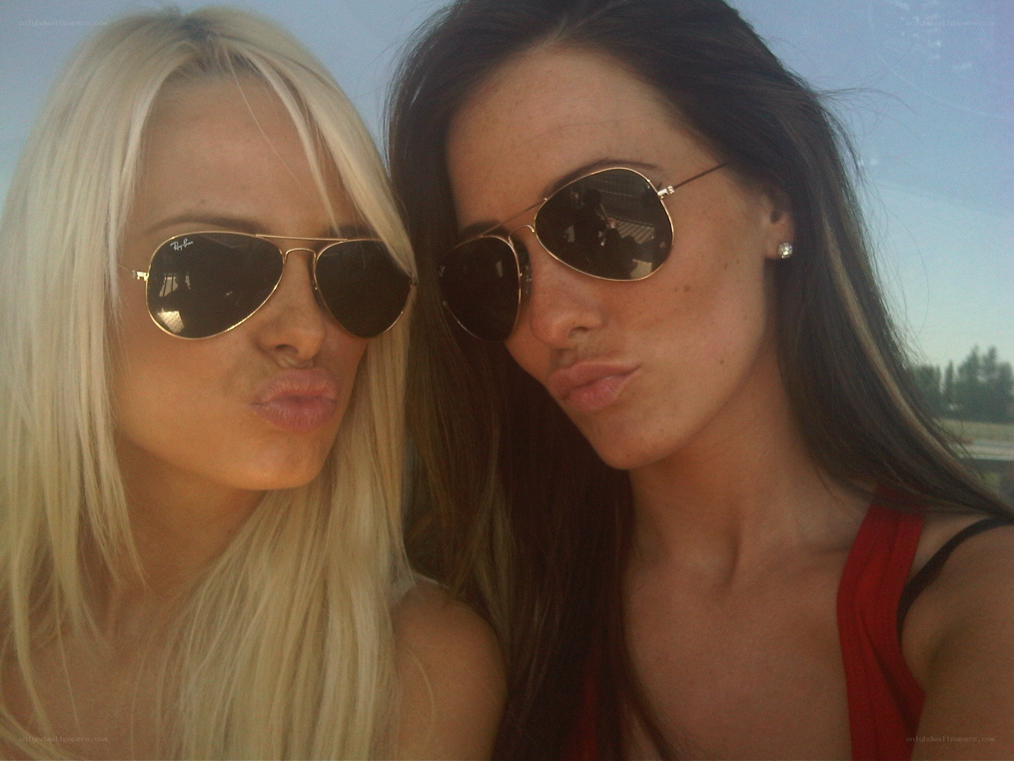 two women in sunglasses posing