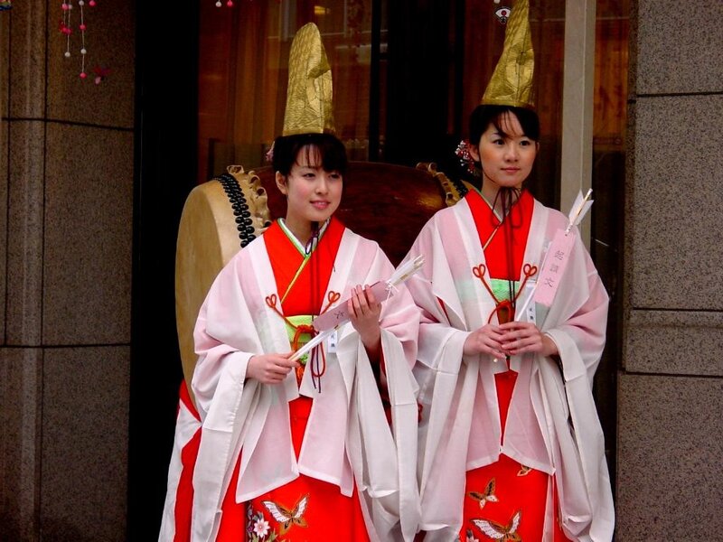 Two Women in Traditional Attire — Red, Formal
