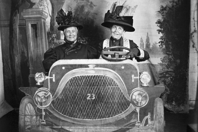 Two women in vintage car prop