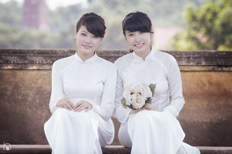 Two women in white ao dai
