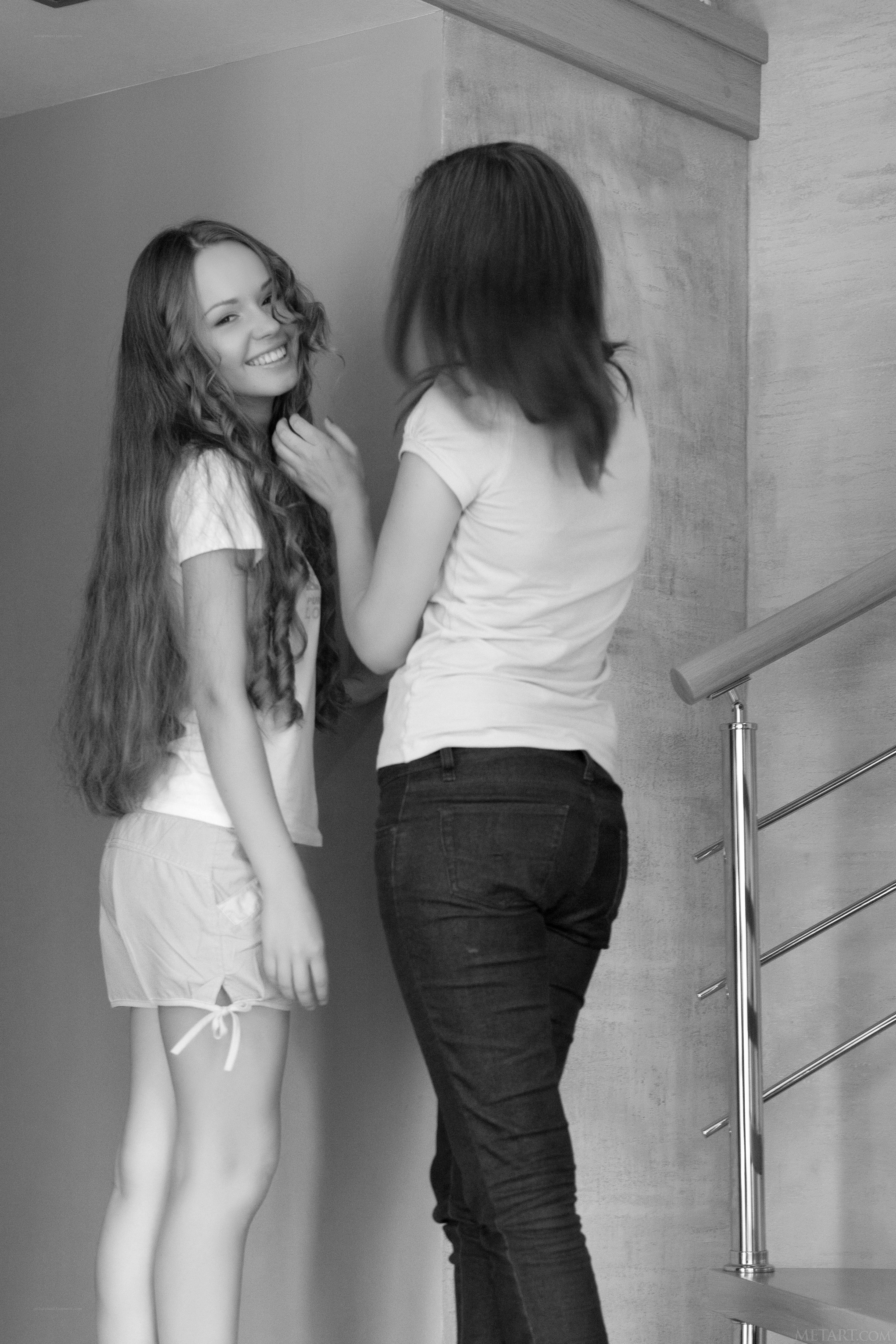 Two women interacting on stairs