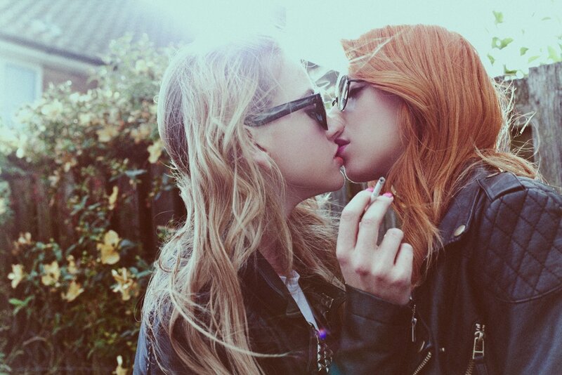 Two women kissing outdoors