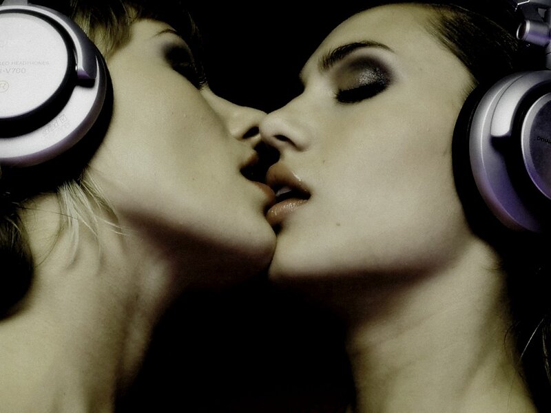 two women kissing with headphones