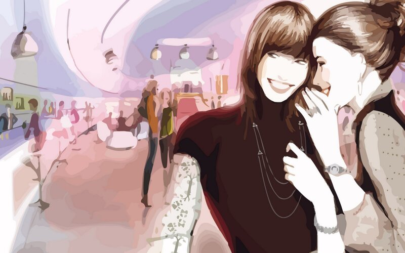 two women laughing in a cafe