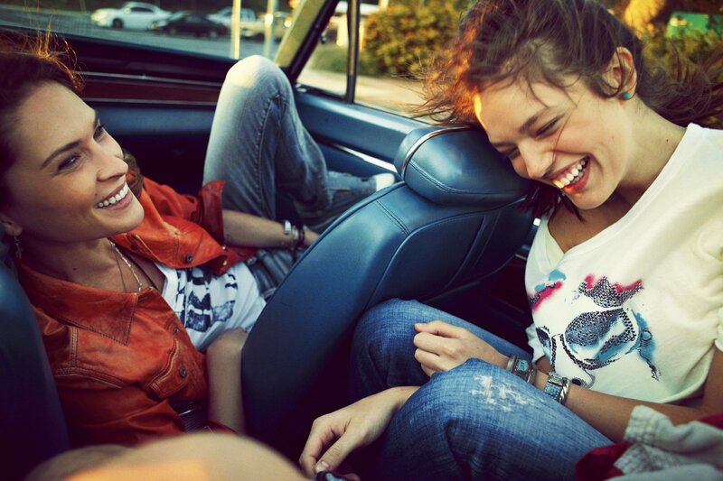 Two women laughing in a car