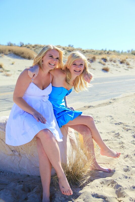 Two women laughing on a beach