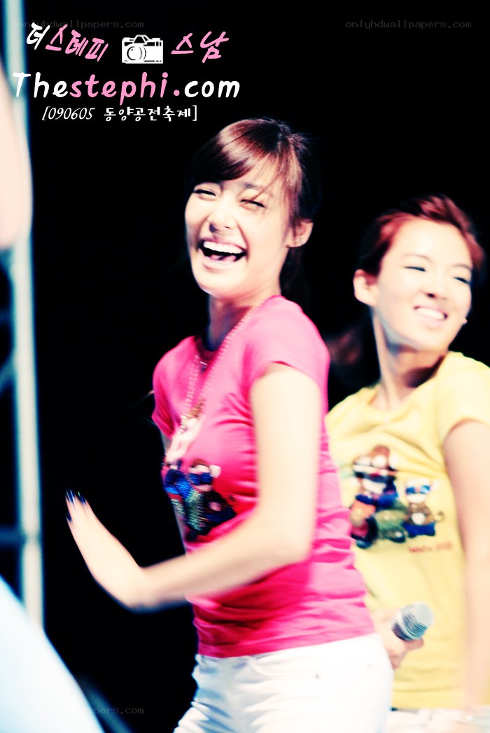 two women laughing on stage