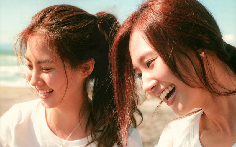 Two women laughing on the beach