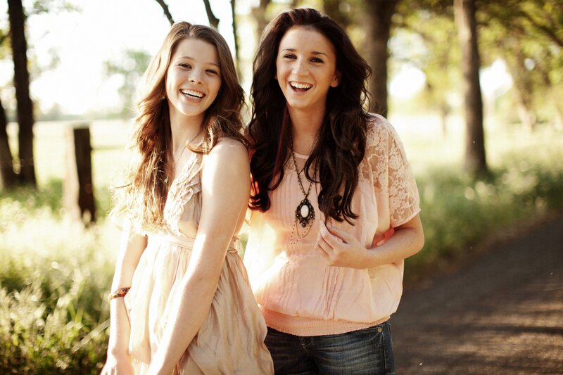 two women laughing outdoors