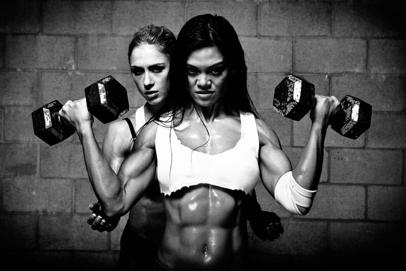 two women lifting weights