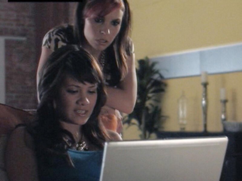 Two women looking at a laptop