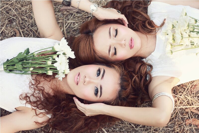 Two Women Lying Down — White, Serene, Afternoon