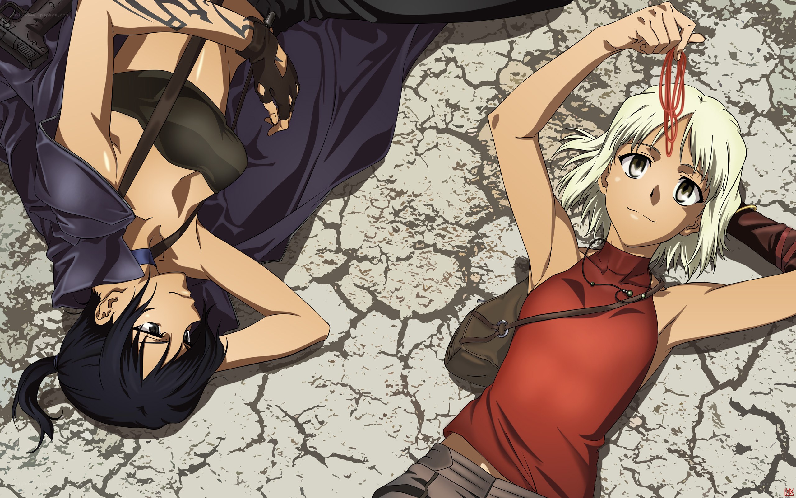 Two women lying on cracked ground