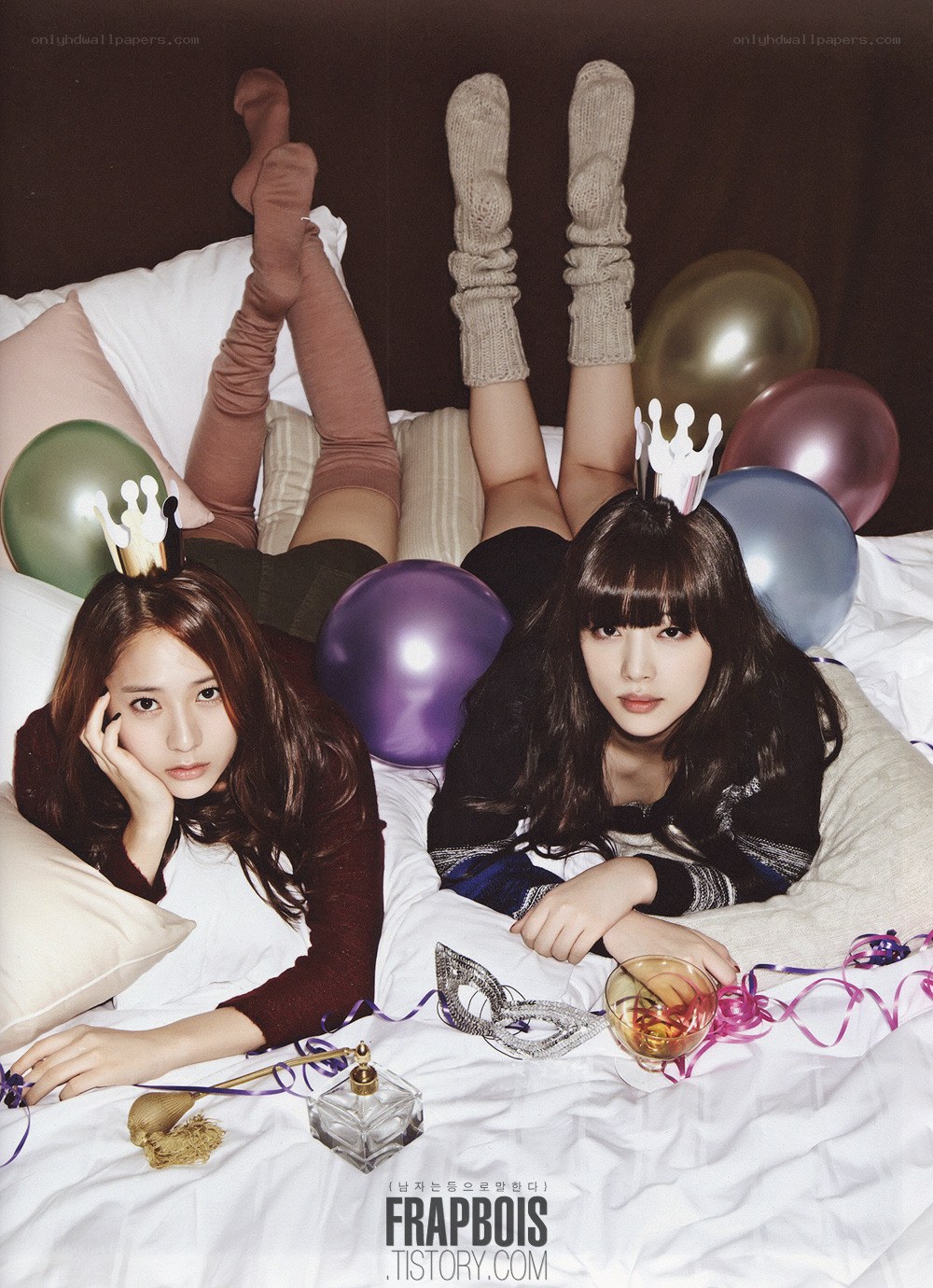 Two women on a bed with balloons