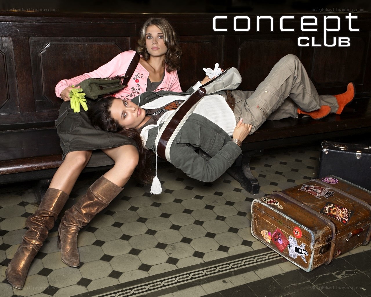 Two women on a bench with luggage