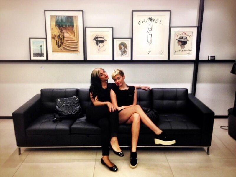 Two women on a black couch