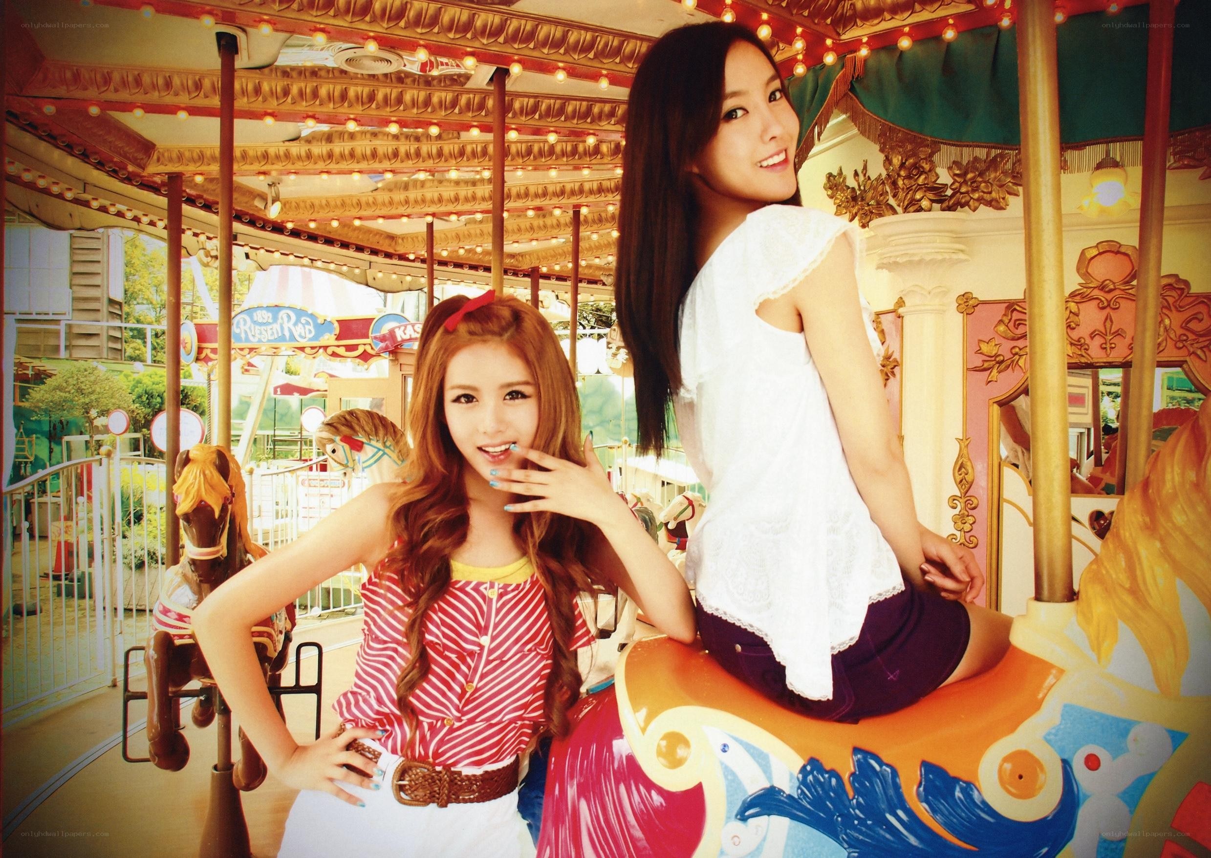 Two women on a carousel