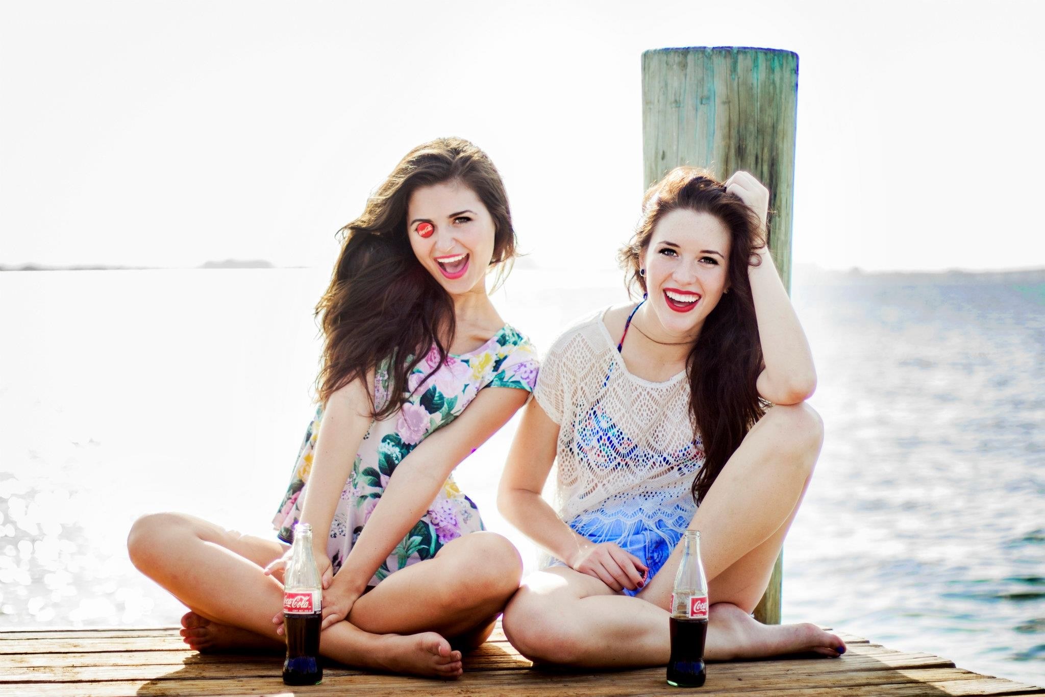 Two women on a dock with Coca-Cola