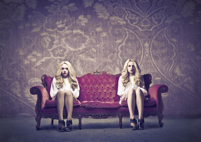 Two women on a red couch