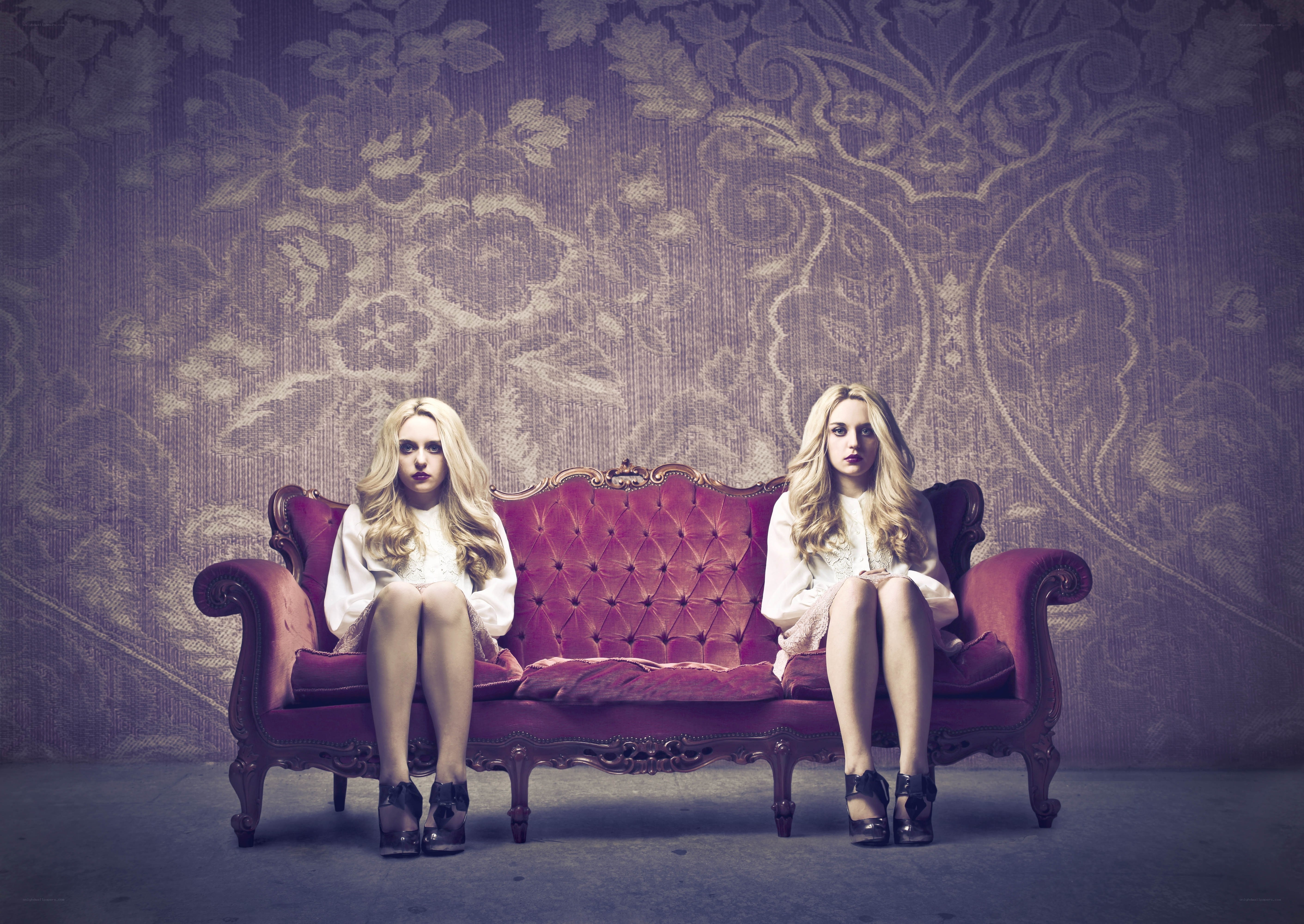 Two women on a red couch
