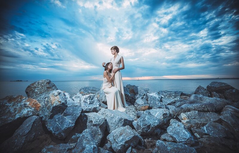 Two Women on Rocks — Blue, Dramatic, Sunset, Photograph