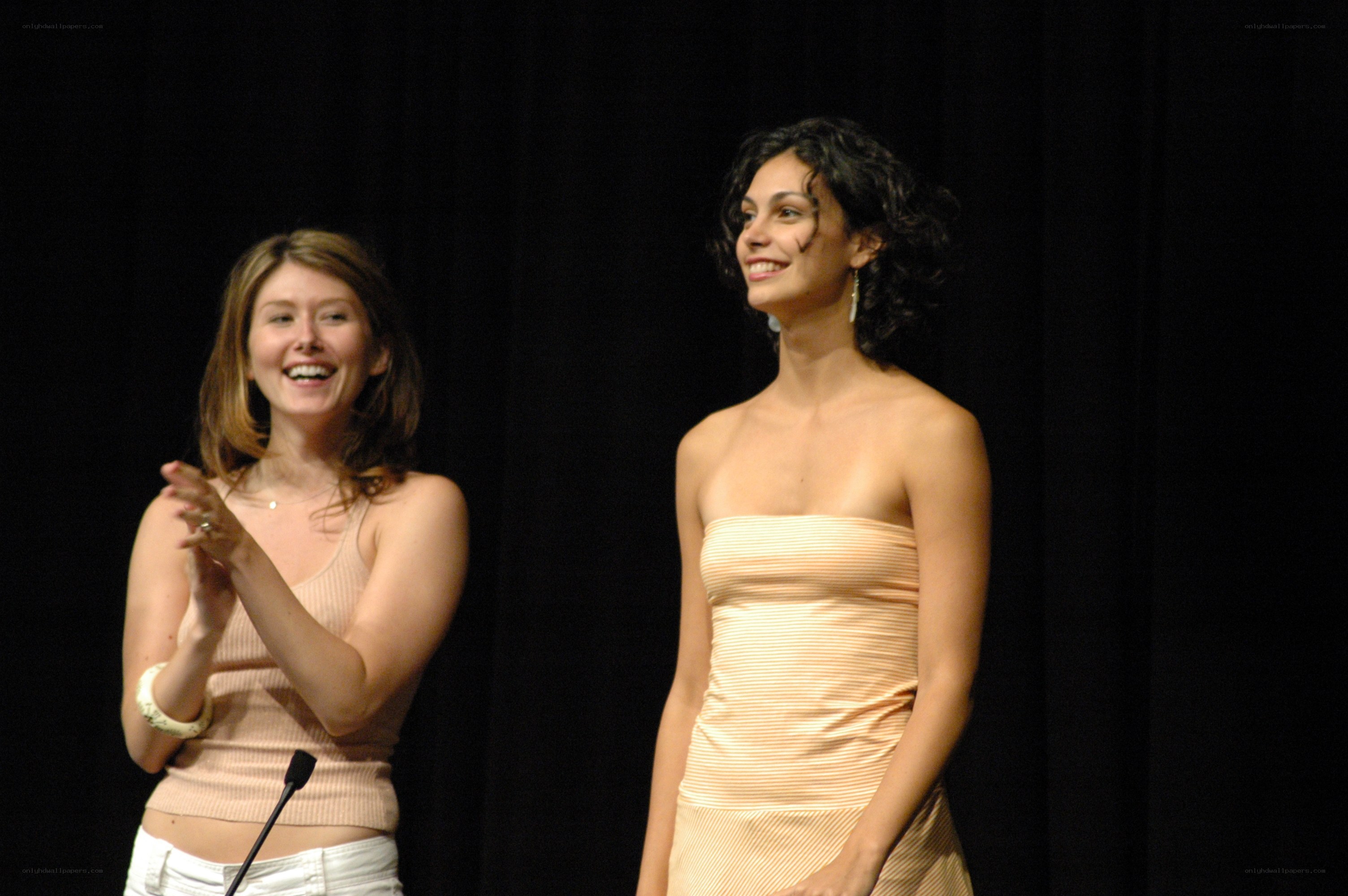 Two women on stage clapping